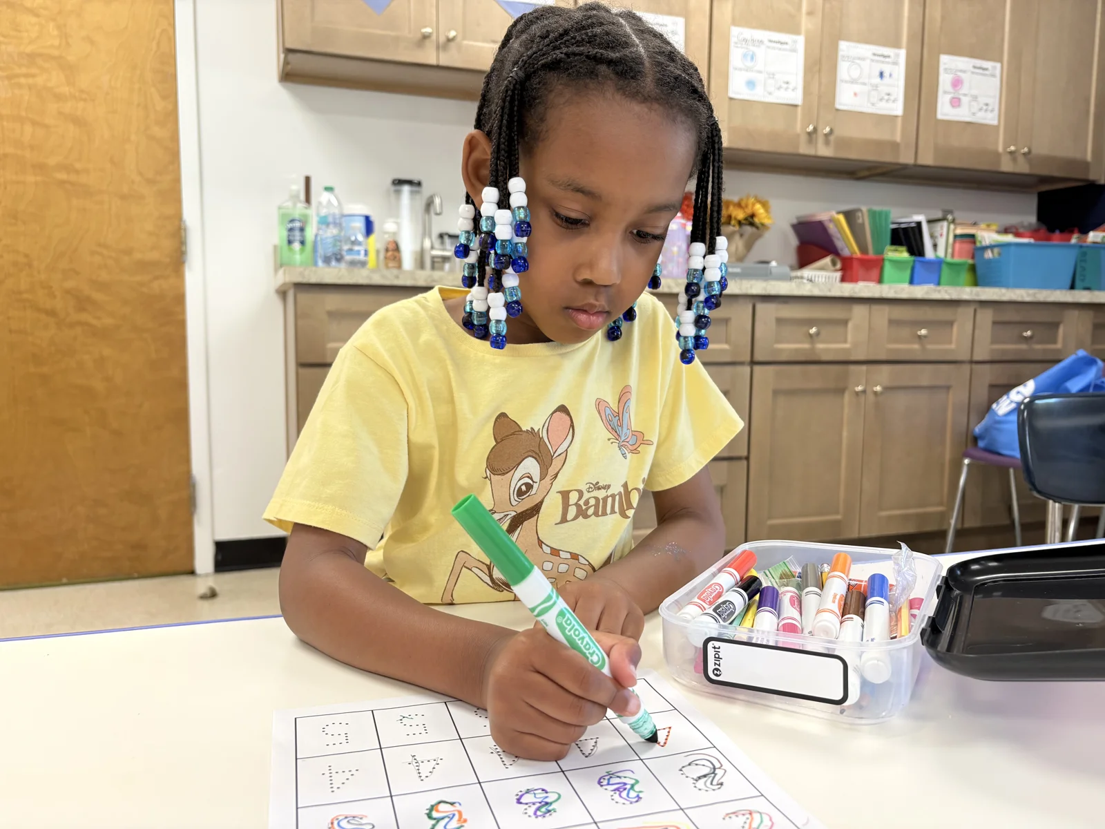 A Lower Elementary student working on a word-search activity in a Laurel classroom