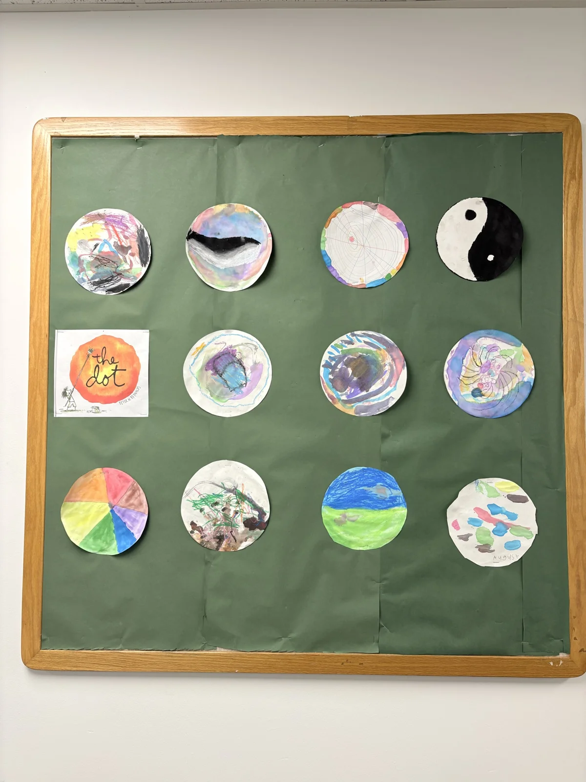 A bulletin board of student circle paintings