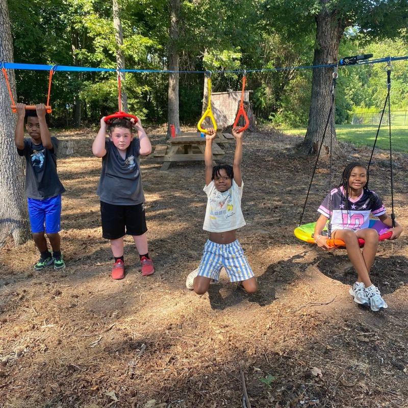 Students on the swings in the Play Forest