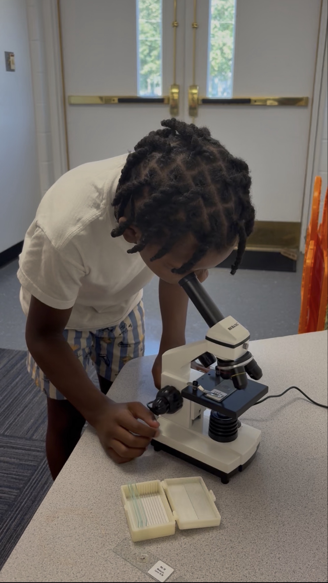 A student using a microscope during a science lesson at The Laurel School
