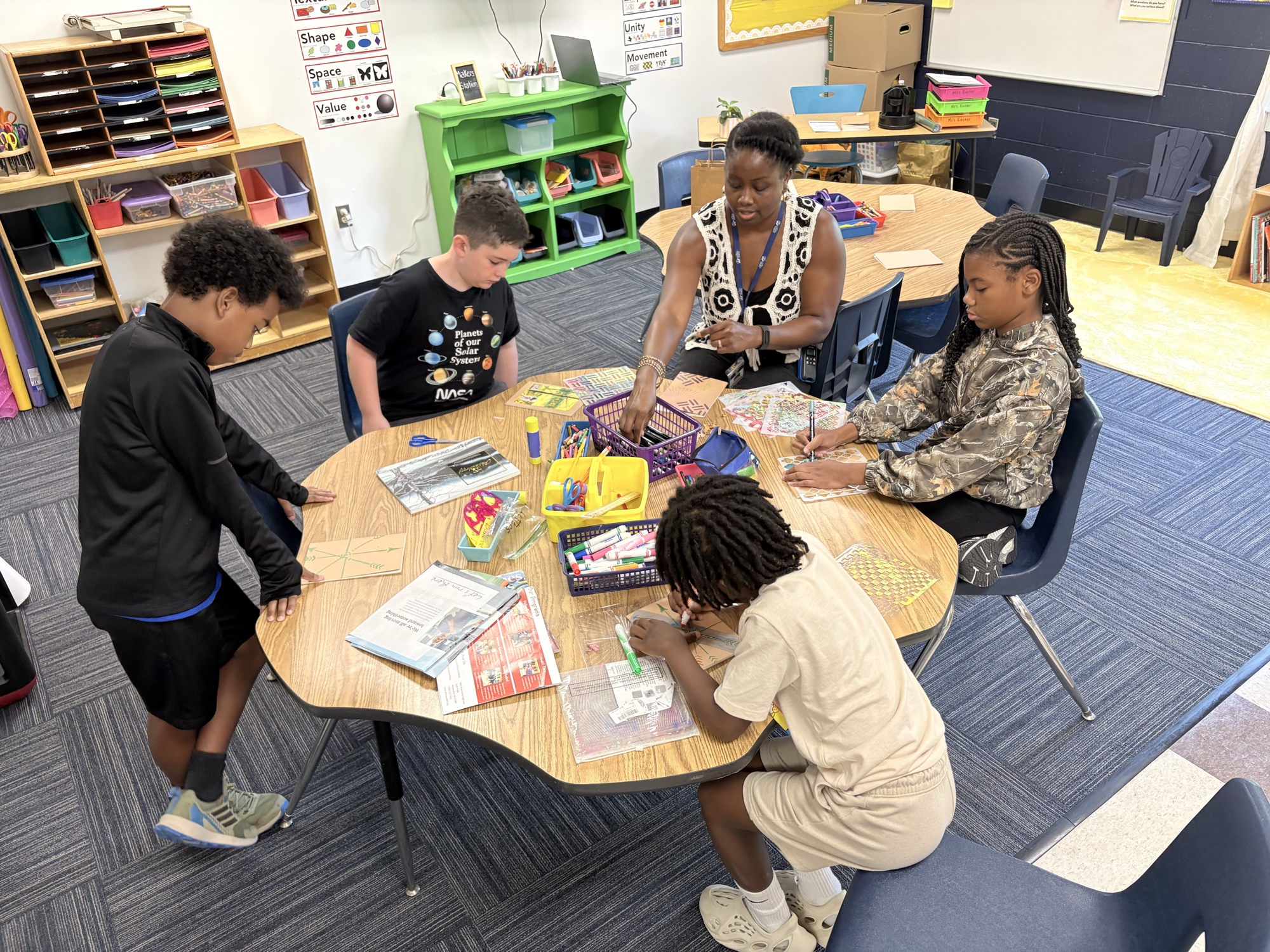 A teacher and students collaborating on a makers project in the Laurel School classroom